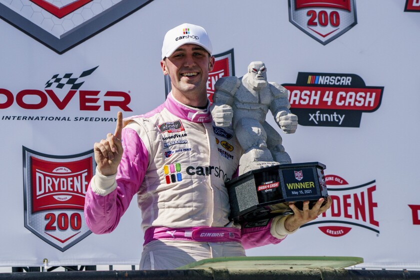 Austin Cindric holds the trophy following his victory in a NASCAR Xfinity Series auto race at Dover International Speedway, Saturday, May 15, 2021, in Dover, Del. (AP Photo/Chris Szagola)