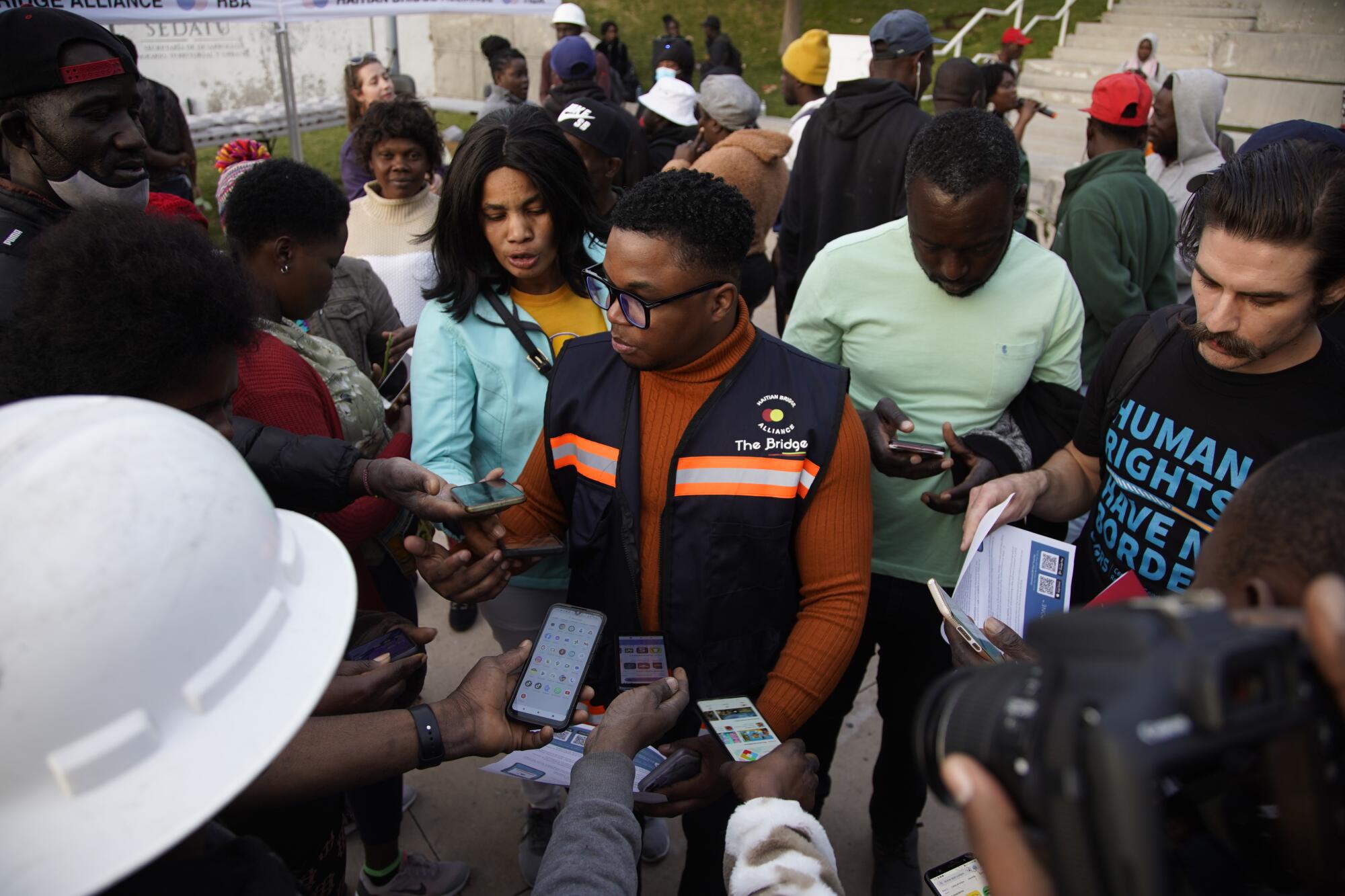 Jean Jeef Nelson of Haitian Bridge Alliance tells Haitian asylum seekers about the CBP One app