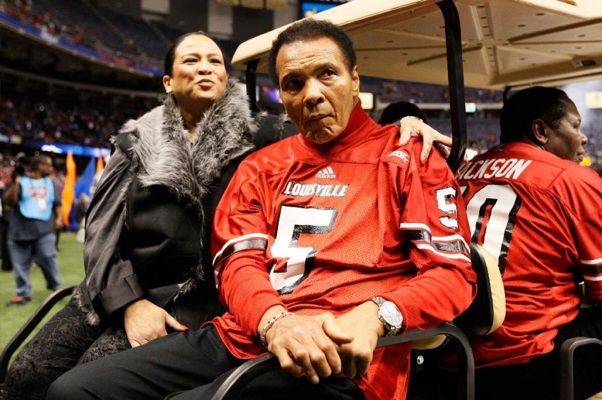 Muhammad Ali rides a golf cart onto the field for the coin toss before the start of the Sugar Bowl.