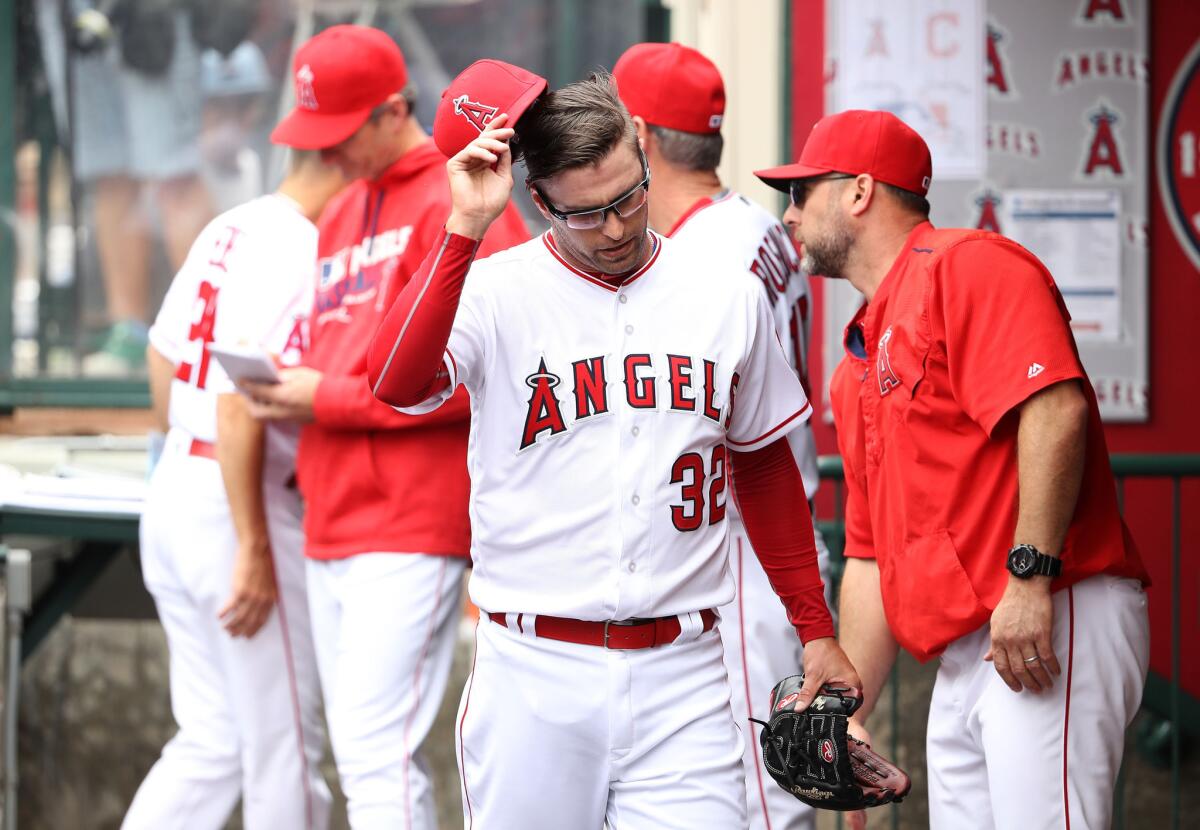 Angels pitcher David Huff (32) takes his hat off Sunday after being pulled in the second inning of his team's game against the Cleveland Indians.