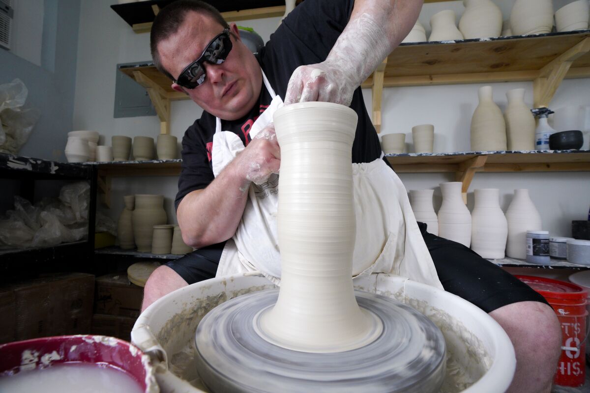 Kelvin Crosby, 33, of Old Town San Diego works in his ceramic studio in Clairemont on Friday.  