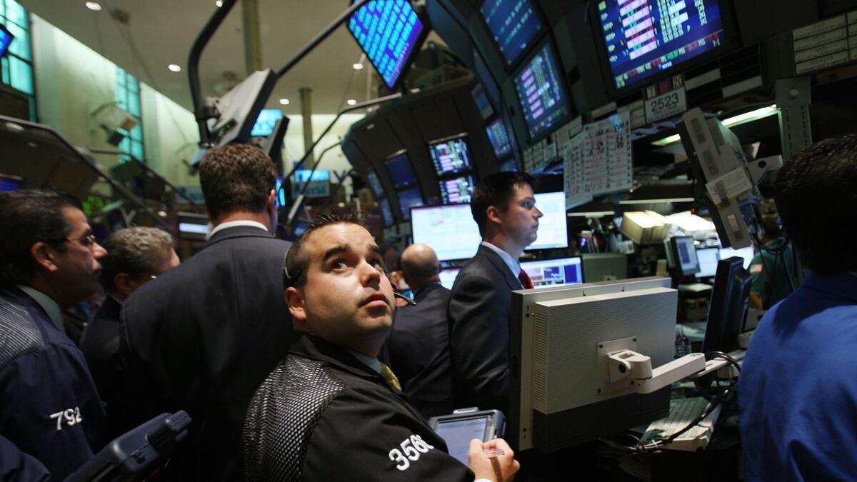 Traders work on the floor of the New York Stock Exchange in New York City as financial markets tumble on Sept. 15, 2008.