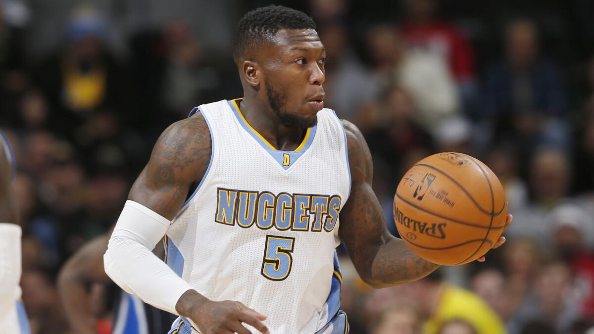 Denver Nuggets guard Nate Robinson dribbles the ball during a game against the Orlando Magic on Jan. 7. Robinson will make his debut with the Clippers against the Golden State Warriors on Sunday.