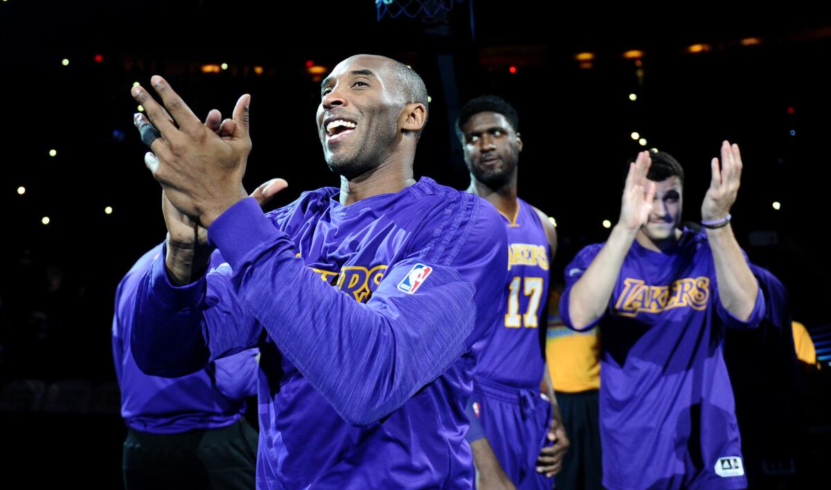 Lakers forward Kobe Bryant waves to the crowd as he is introduced before a game against the Thunder.