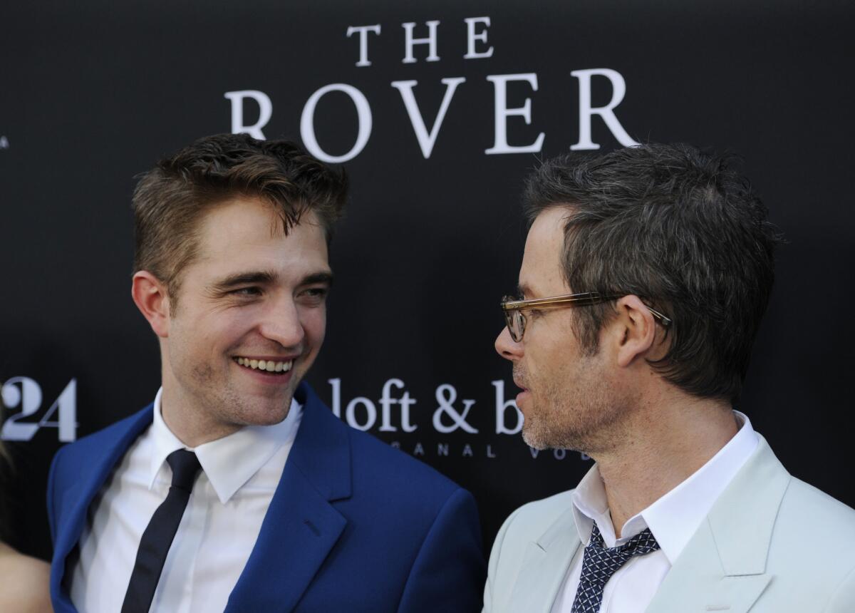 "The Rover" costars Robert Pattinson, left, and Guy Pearce converse at the film's U.S. premiere Thursday in Los Angeles.