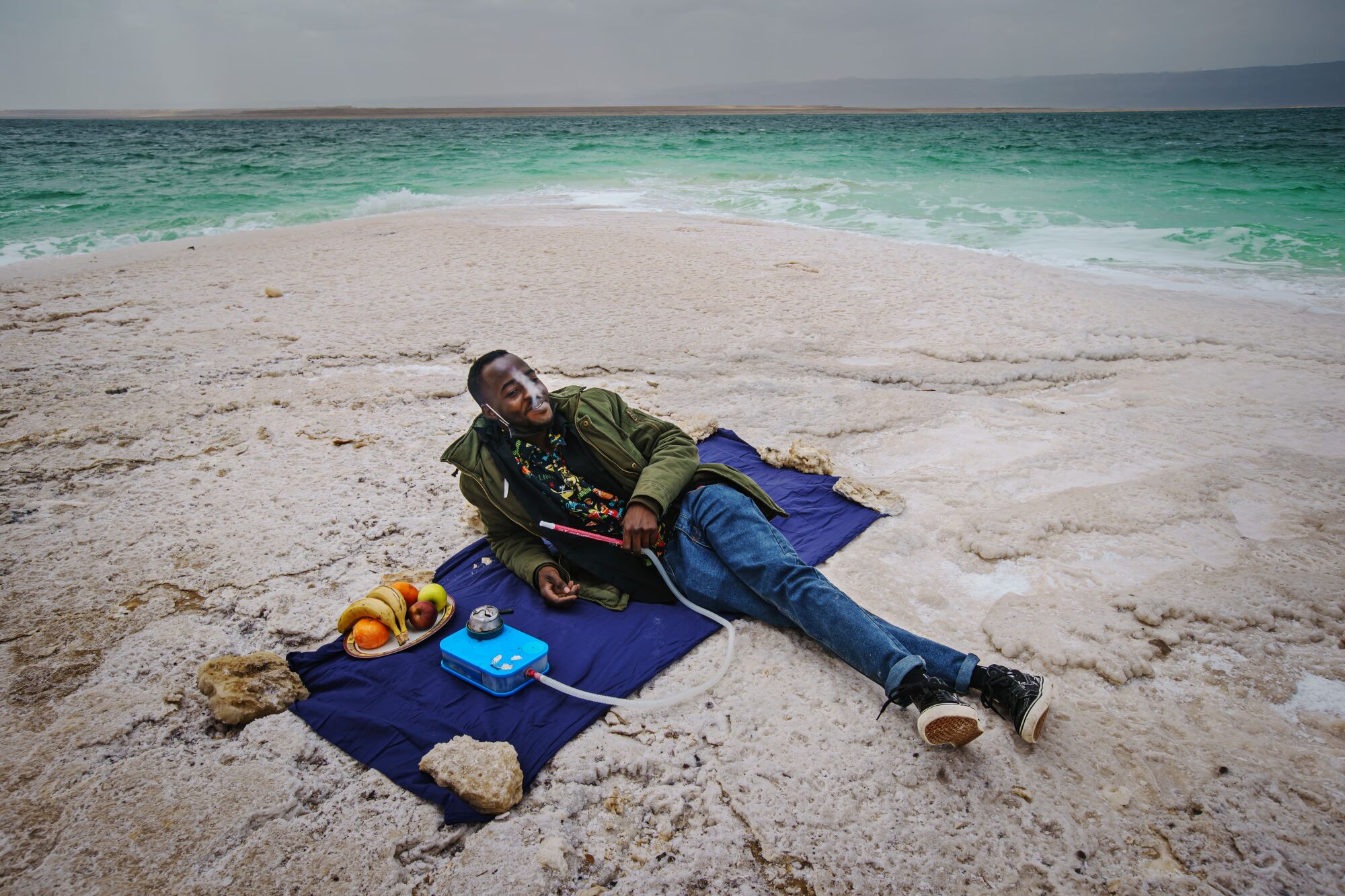 A man picnics by the Dead Sea.