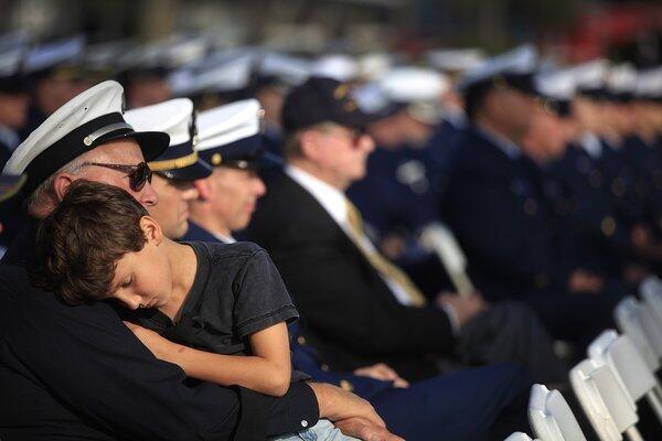 J.P. Vermillion, 9, of Palos Verdes Estates, rests in the arms of his father, Perry, of the Los Angeles County Fire Department at the service for the Coast Guard's Senior Chief Petty Officer Terrell Horne. Horne was killed on Dec. 2 when his boat was rammed by an alleged smuggler's vessel near Santa Cruz Island several miles off the coast of California.