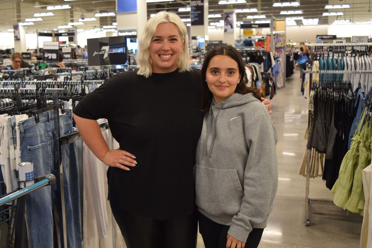 Alyson Beukema, left, shops at Nordstrom Rack in San Clemente with her “little” Emily.