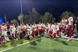 Orange Lutheran players gather after overcoming a 26-7 halftime deficit to beat Sierra Canyon 33-26.