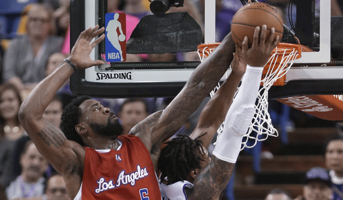 DeAndre Jordan blocks a shot by Sacramento forward Derrick Williams during the Clippers' 117-108 victory Saturday night.