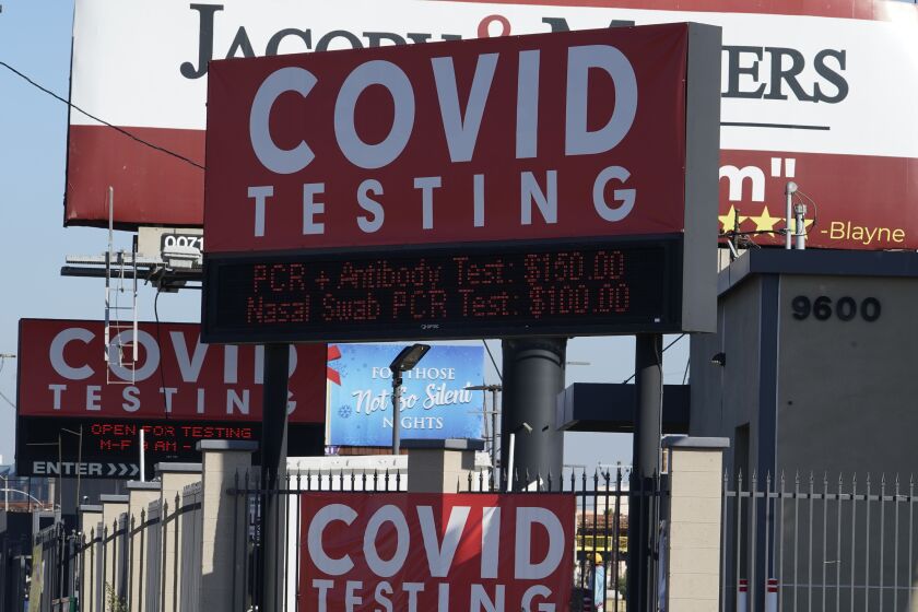 Advertisements for Covid-19 testing ares posted outside Los Angeles International Airport in Los Angeles, Friday, Nov. 13, 2020. California has become the second state to record 1 million confirmed coronavirus infections. The governors of California, Oregon and Washington issued travel advisories Friday, Nov. 13, 2020, urging people entering their states or returning from outside the states to self-quarantine to slow the spread of the coronavirus, California Gov. Gavin Newsom's office said. The advisories urge people to avoid non-essential out-of-state travel, ask people to self-quarantine for 14 days after arriving from another state or country and encourage residents to stay local, a statement said. (AP Photo/Damian Dovarganes)