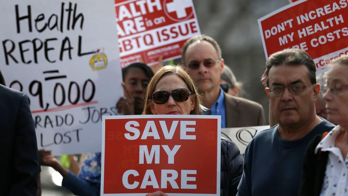 Opponents of Colorado Republicans' plan to undo their state-run insurance exchange gather for a rally on the state Capitol steps in Denver Feb. 7. A bill being heard in the Senate Finance Committee would abolish the exchange.