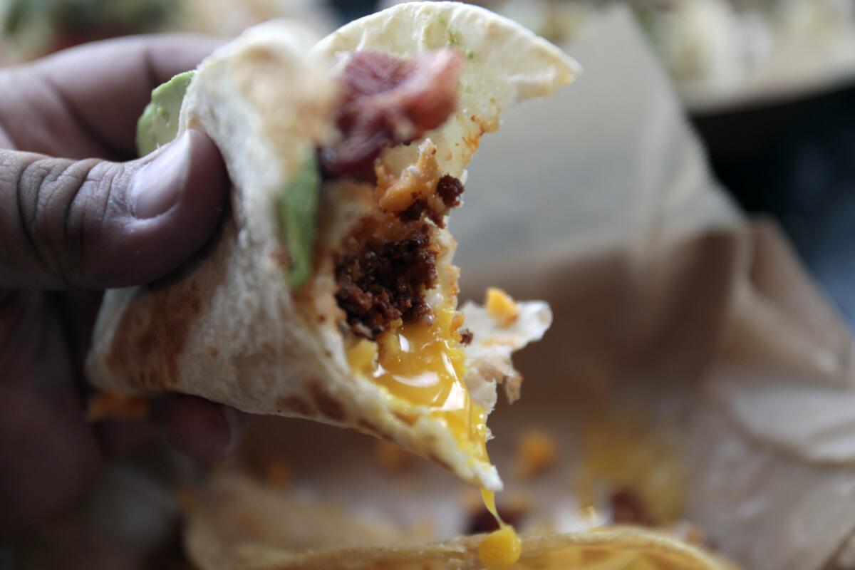 The breakfast taco with chorizo, bacon, an overeasy egg, sharp cheddar, cotija and avocado on a hand pressed flour tortilla at ¡Salud! in the San Diego neighborhood of Barrio Logan on Jan. 20.