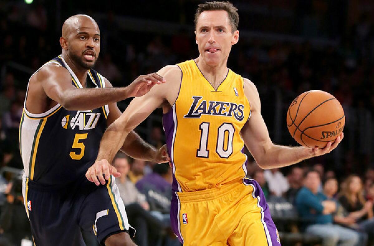 Lakers point guard Steve Nash drives past Jazz point guard John Lucas III during a preseason game at Staples Center.