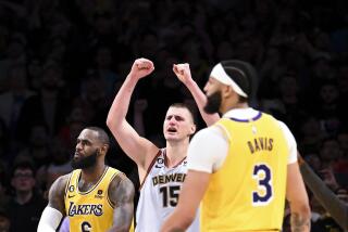 Nuggets center Nikola Jokic, center, celebrates after defeating LeBron James, left, Anthony Davis and the Lakers on May 22.