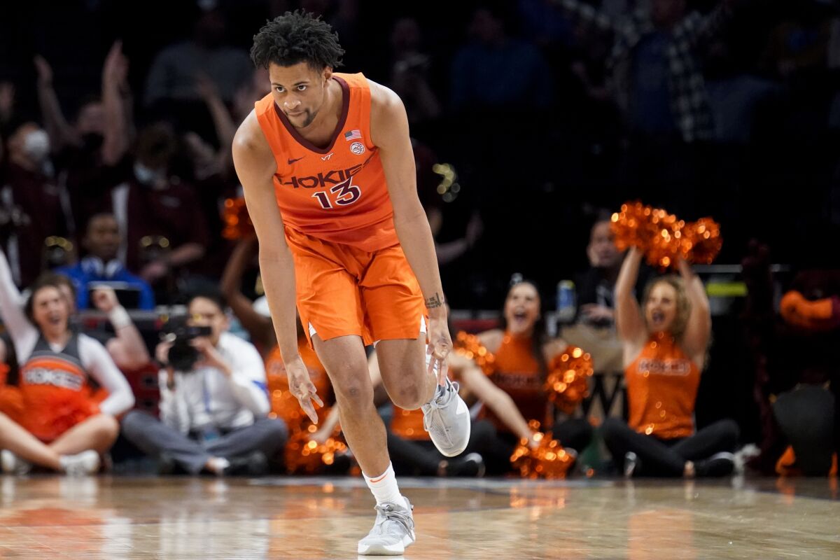 Virginia Tech's Darius Maddox (13) reacts after scoring three points in the second half of an NCAA college basketball game against North Carolina during semifinals of the Atlantic Coast Conference men's tournament, Saturday, March 12, 2022, in New York. (AP Photo/John Minchillo)