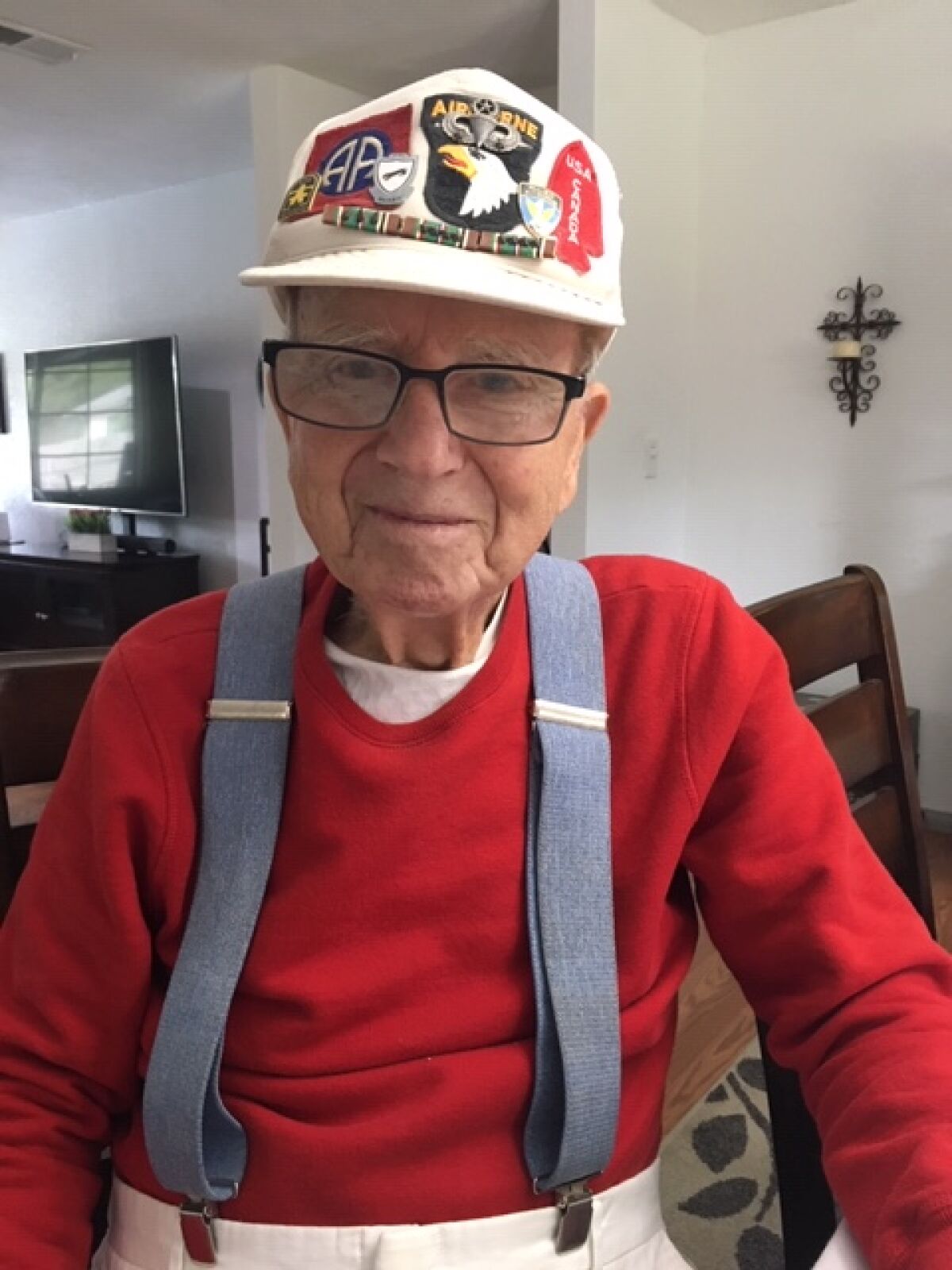 Joseph Stolmeier wearing his veteran's baseball cap displaying his World War II medallions.<br>