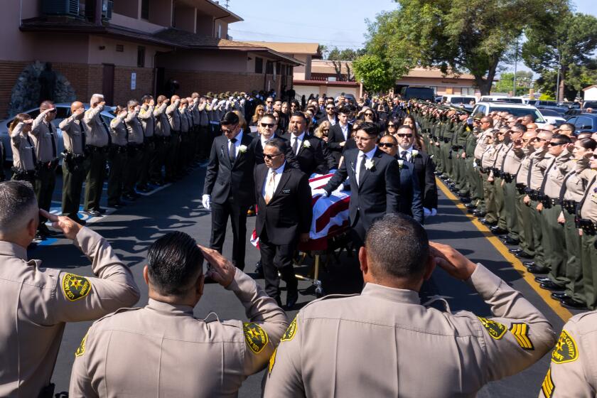 Sylmar, CA - May 09: Los Angeles County Sheriff's Deputy Freddy Flores's casket is carried into St. Didicus Catholic Church for his funeral mass on Thursday, May 9, 2024 in Sylmar, CA. (Brian van der Brug / Los Angeles Times)
