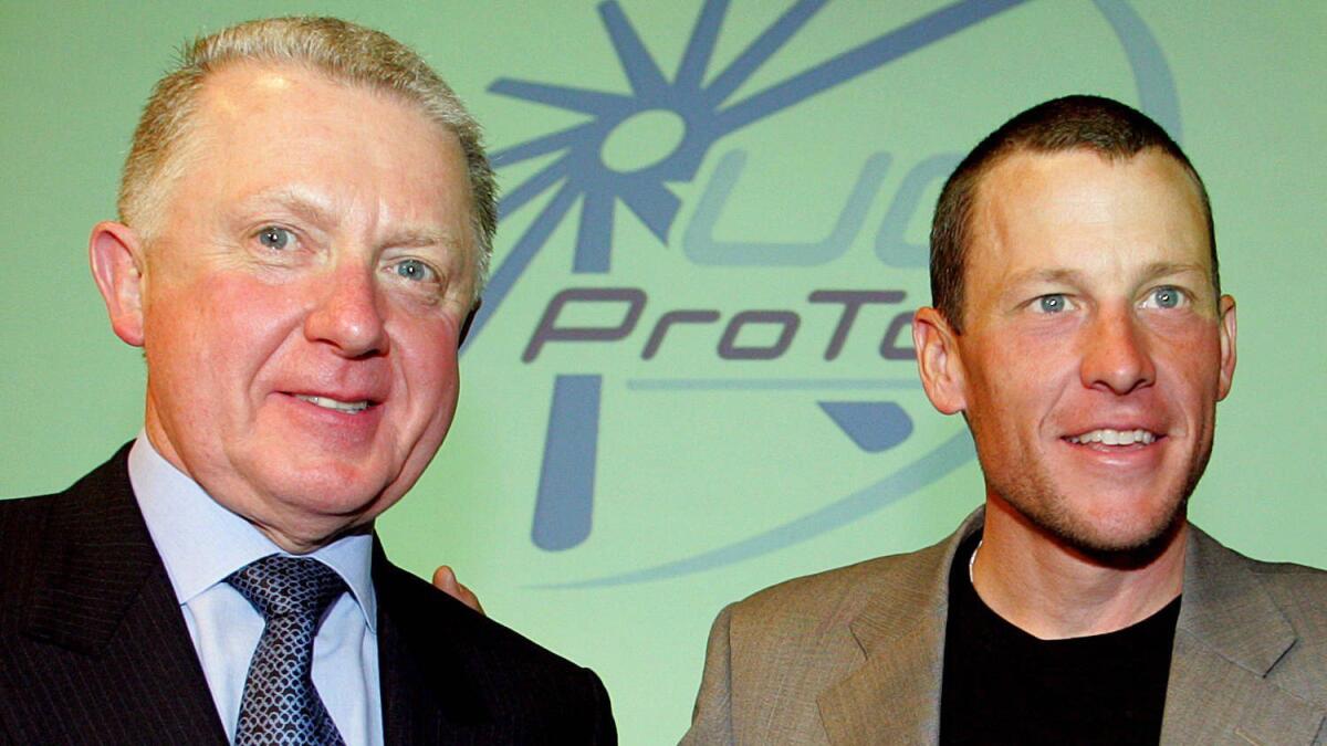 Former International Cycling Union President Hein Verbruggen, left, poses for a photo with cyclist Lance Armstrong in Paris in 2003.