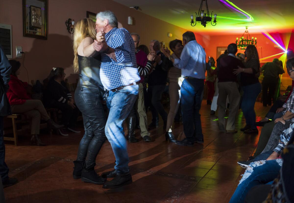 The women are in command on the dance floor as the men are slower, clumsier and struggling to keep up. (Angel Navarrete / For the Times)