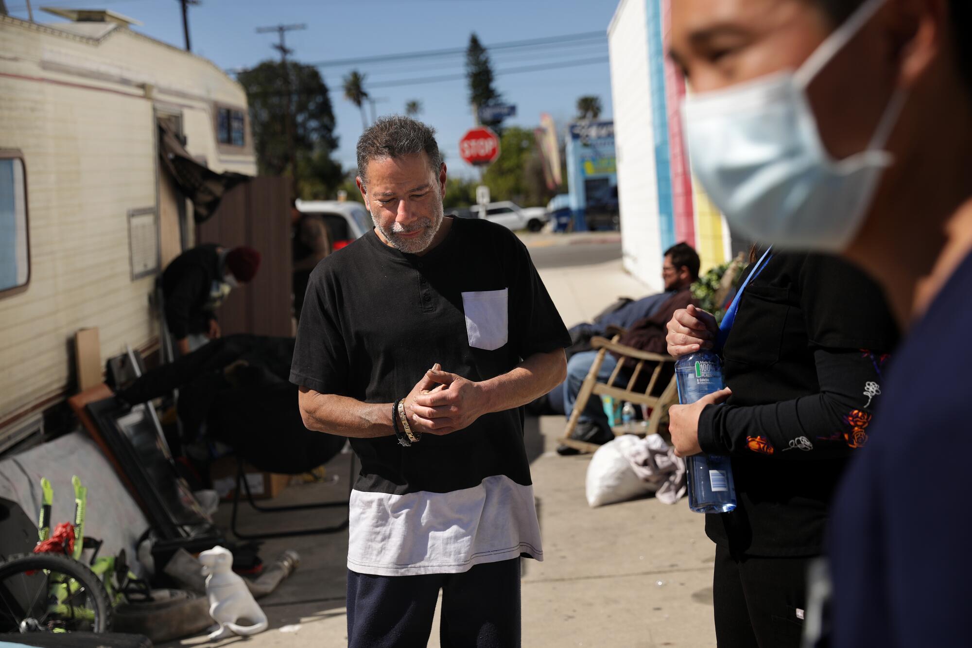 Manny Placeres is visited in North Hollywood by an L.A. County Department of Health Services medical team on March 7, 2022. 