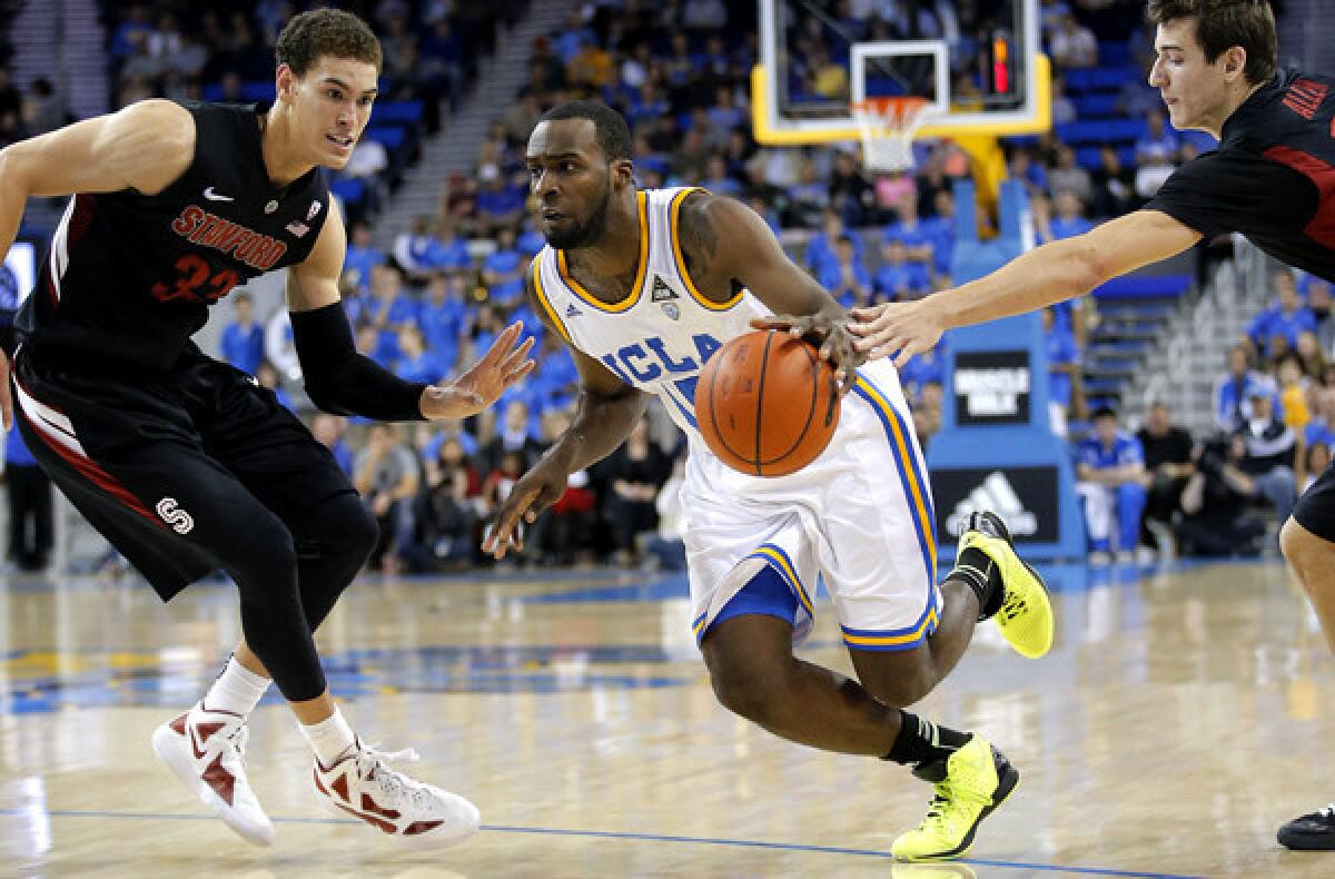 UCLA swingman Shabazz Muhammad splits the defense of Stanford's Dwight Powell, left, and Rosco Allen in the second half Saturday.