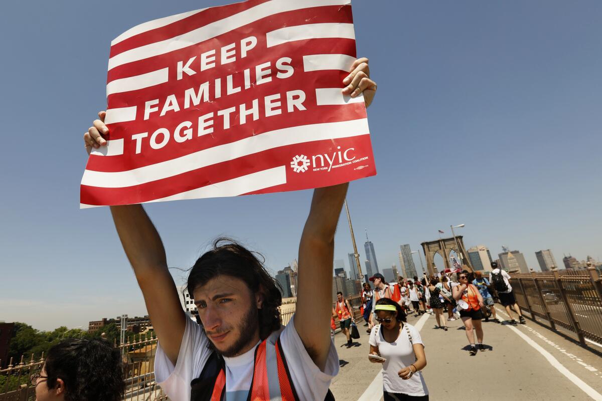 NEW YORK: Ariel Schwartz, 19, of Long Island, takes part in a march to keep families together. "I'm sick and tired of innocent families being treated like criminals," Schwartz said.