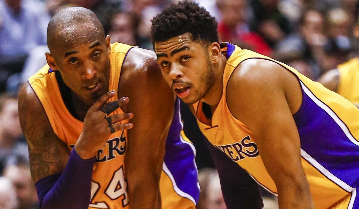 Kobe Bryant, left, talks with Lakers rookie D'Angelo Russell during a game against Milwaukee on Feb. 22.