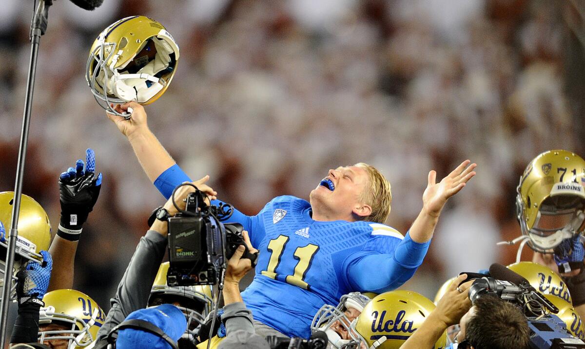 UCLA quarterback Jerry Neuheisel is lifted into the air after leading the Bruins to a comeback victory over Texas in Arlington on Sept. 13.