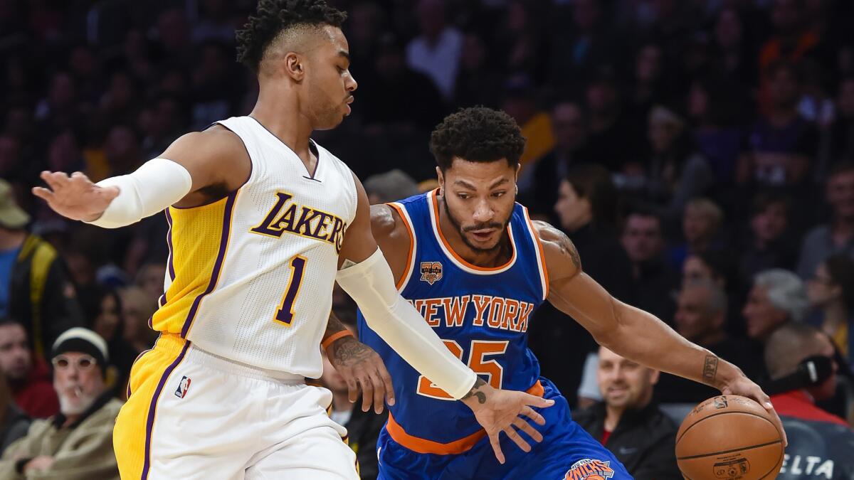 New York Knicks guard Derrick Rose (25) attempts to get by Los Angeles Lakers guard D'Angelo Russell (1) during the first half of an NBA basketball game, Sunday, Dec. 11, 2016, in Los Angeles.(AP Photo/Gus Ruelas)