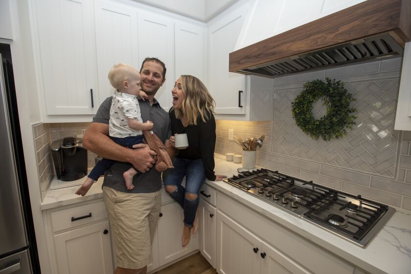 El Dorado Hills, Calif. -- Thursday, May 27, 2021: Brian and Rebecca Luke their with son Bennett, 1, in the kitchen of their new home in El Dorado Hills, Calif., on May 27, 2021. (Brian van der Brug / Los Angeles Times)