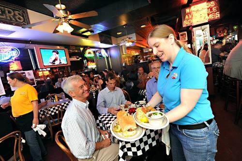 Customer Denny Byrne awaits his order from waitress Megan Malone at Acme Oyster House in New Orleans' French Quarter, one of the few local restaurants still serving Louisiana oysters into early July in the wake of the BP oil spill. Paul Rotner, the restaurant's director of operations, said he's monitoring the situation closely to determine how long Acme will continue to serve local oysters.