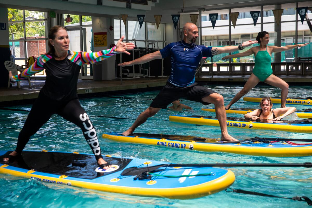 Eric Vandendriessche leads his Aqua Stand Up paddleboard class