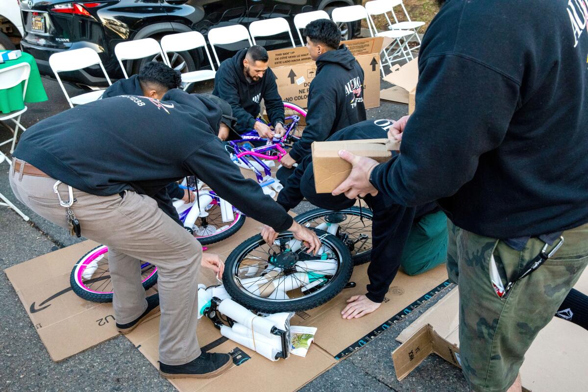 Audio Images employees assembling bicycles to be donated to Serving People In Need.
