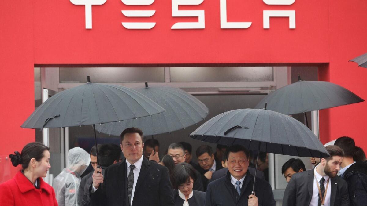Elon Musk, left, walks with Shanghai Mayor Ying Yong during the January ground-breaking ceremony for a Tesla factory in Shanghai.