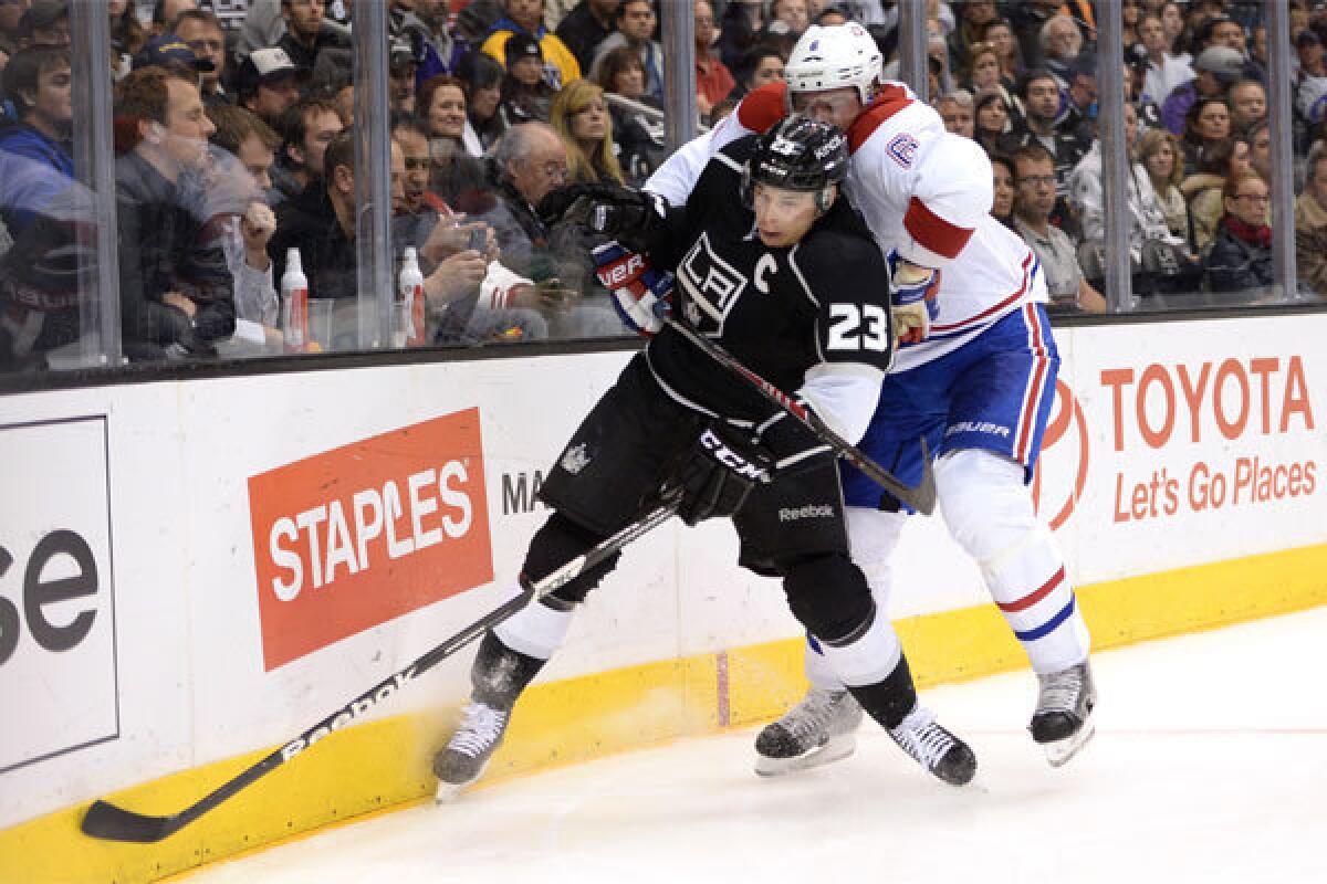 Dustin Brown fends off Montreal's Douglas Murray on March 3 at Staples Center.
