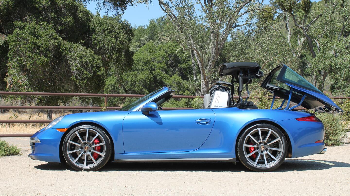 The 2014 Targa 4 and 4S both feature the same large glass rear window and silver "Targa bar" roll bar of the original models.