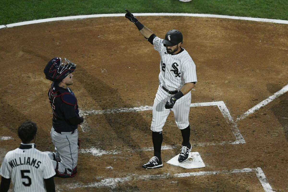 Chicago White Sox's Adam Eaton (12) celebrates at home plate after hitting a three-run home run during the third inning of a baseball game against the Cleveland Indians Monday, April 12, 2021, in Chicago. (AP Photo/Paul Beaty)