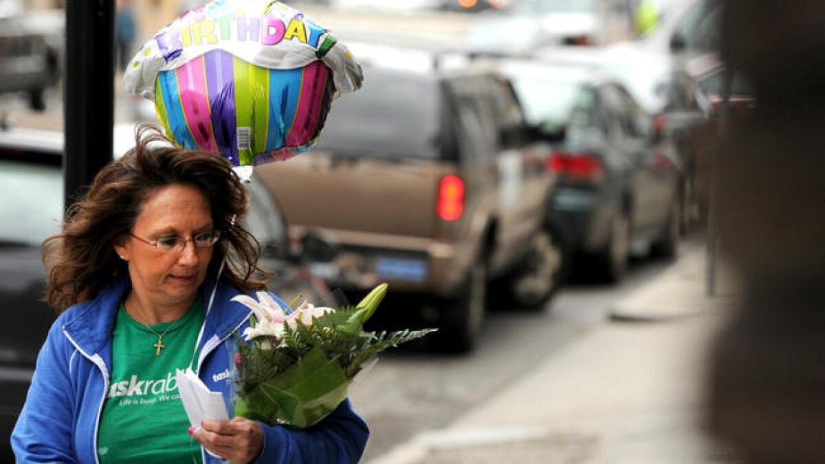 Diane Hohen, with TaskRabbit, delivers a bouquet of flowers in Boston in 2012.