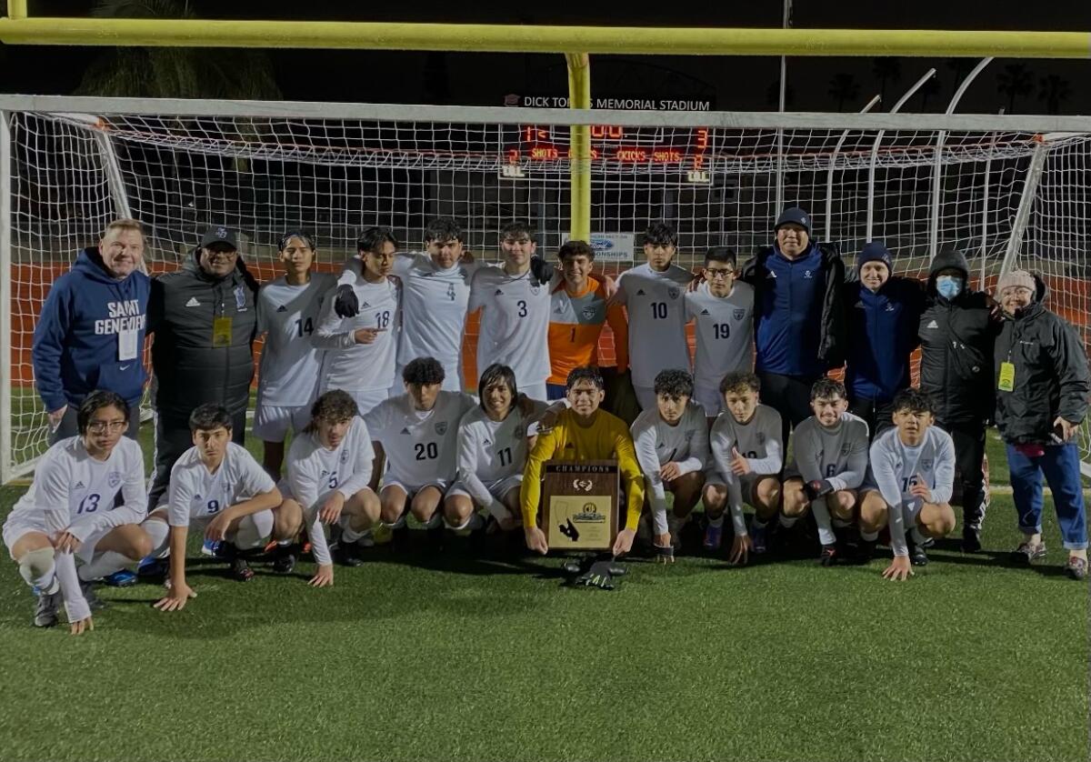 St. Genevieve High's boys' soccer players and coaches pose for a photo.