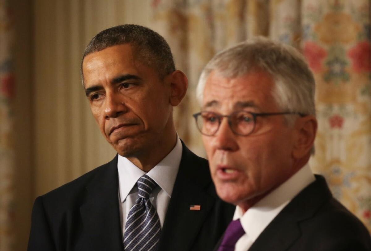 WASHINGTON, DC - NOVEMBER 24: U.S. Secretary of Defense Chuck Hagel, left, speaks as President Barack Obama listens during a press conference announcing Hagel's resignation in the State Dining Room of the White House.