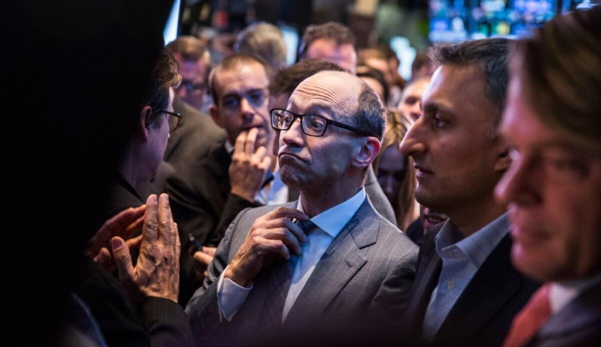 Twitter Chief Executive Dick Costolo adjusts his tie while waiting to see Twitter's opening market price on the floor of the New York Stock Exchange in November. Facebook's blockbuster earnings last week has created high expectations for Twitter investors.