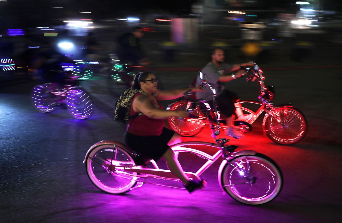 Cyclists flash by in the Venice Electric Light Parade on Aug. 16.