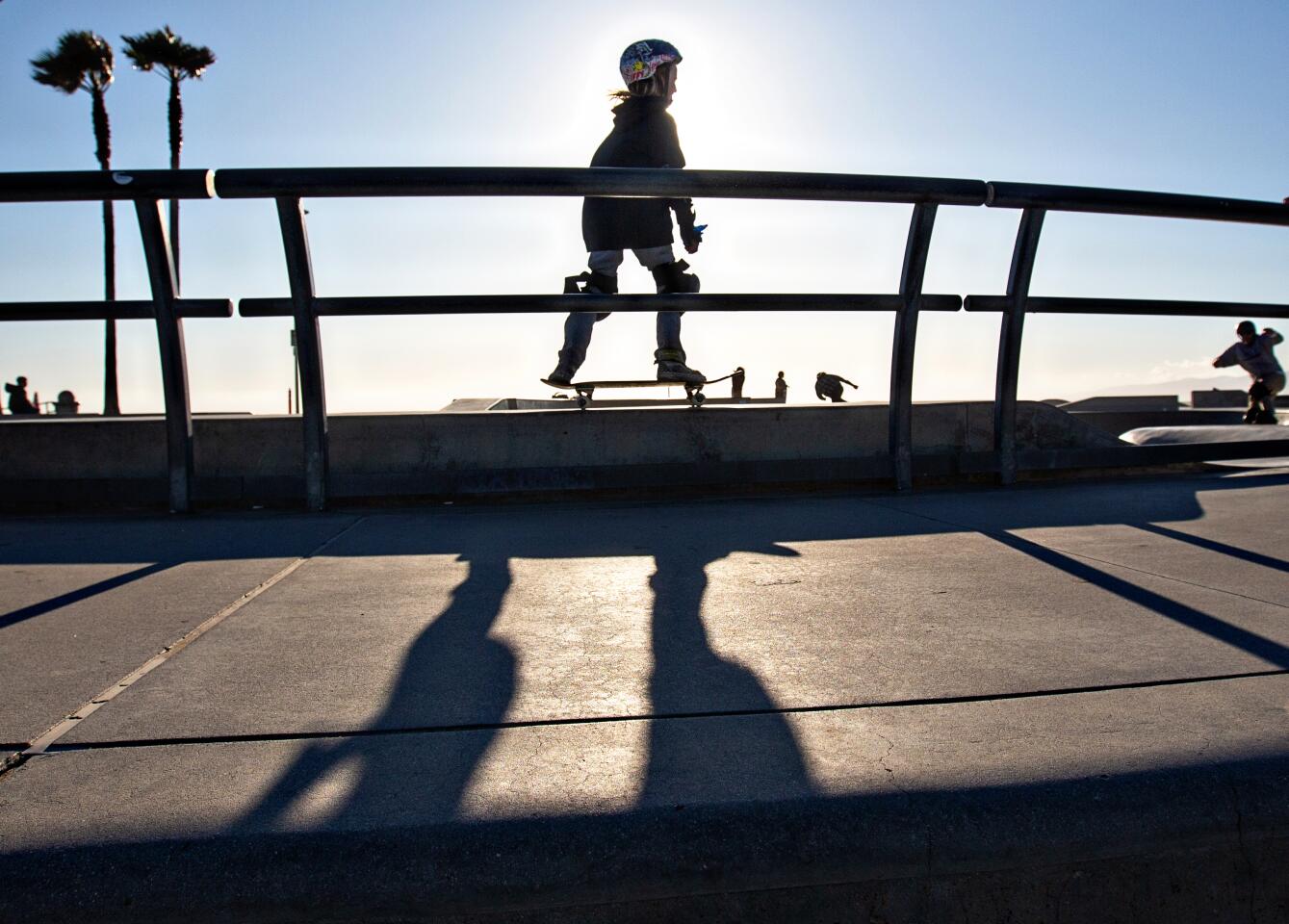 A young skateboarder soaks in the sun while skateboarding at Venice Skate Park on Wednesday in Venice.