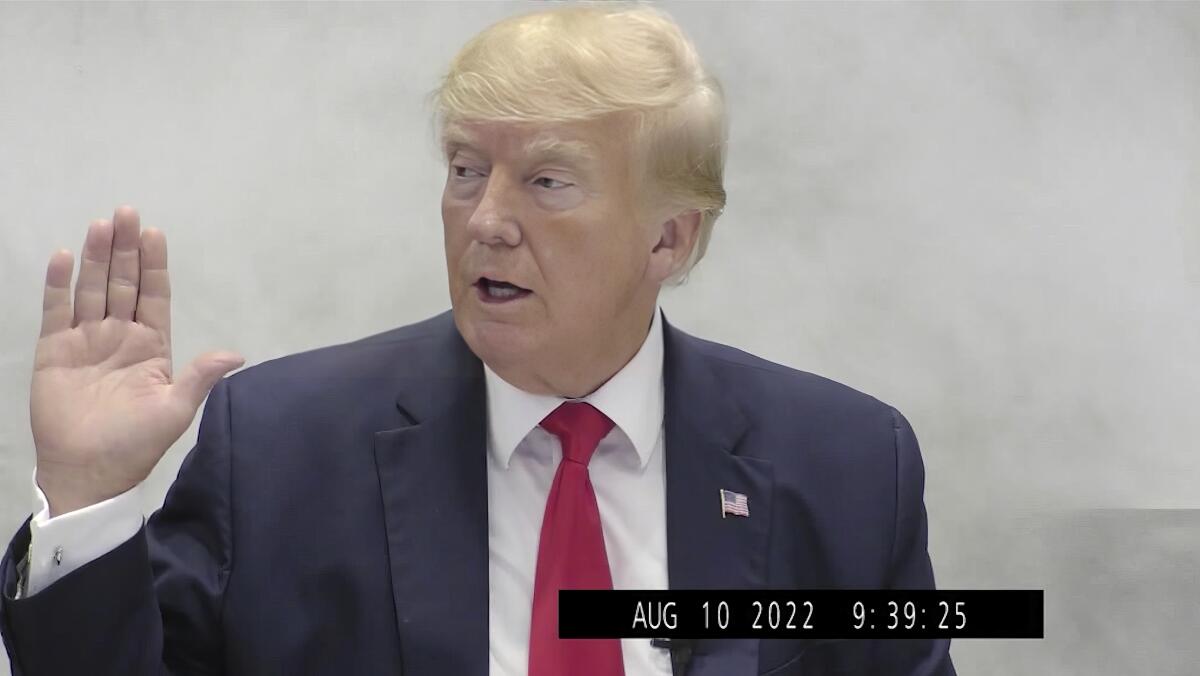 Donald Trump speaking with his right hand raised in an image timestamped "Aug 10 2022 9:39:25."