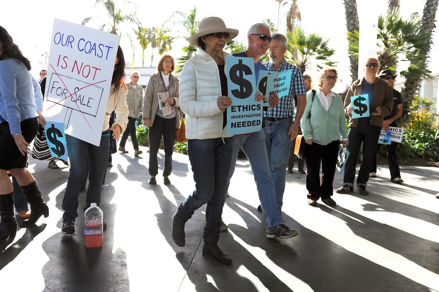 People gather outside the Santa Monica Civic Auditorium for a press conference held by a coalition of community leaders from Venice and activists before the first California Coastal Commission hearing since the firing of Executive Director Charles Lester.