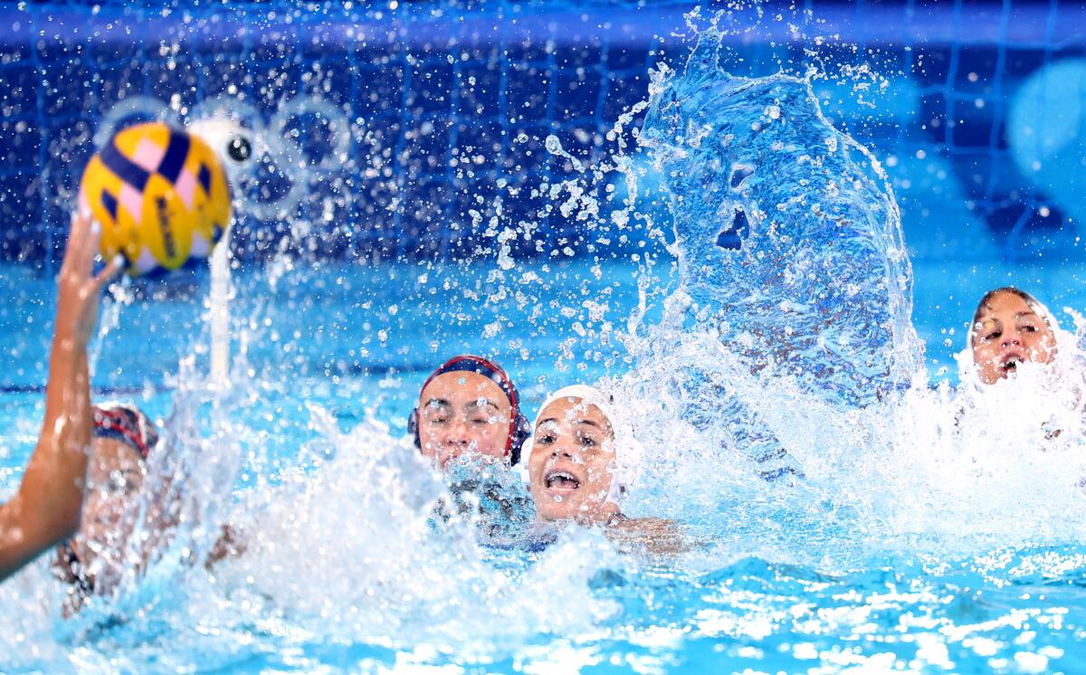 The U.S., wearing blue caps, battles Greece during an Olympic water polo match Saturday in Paris.