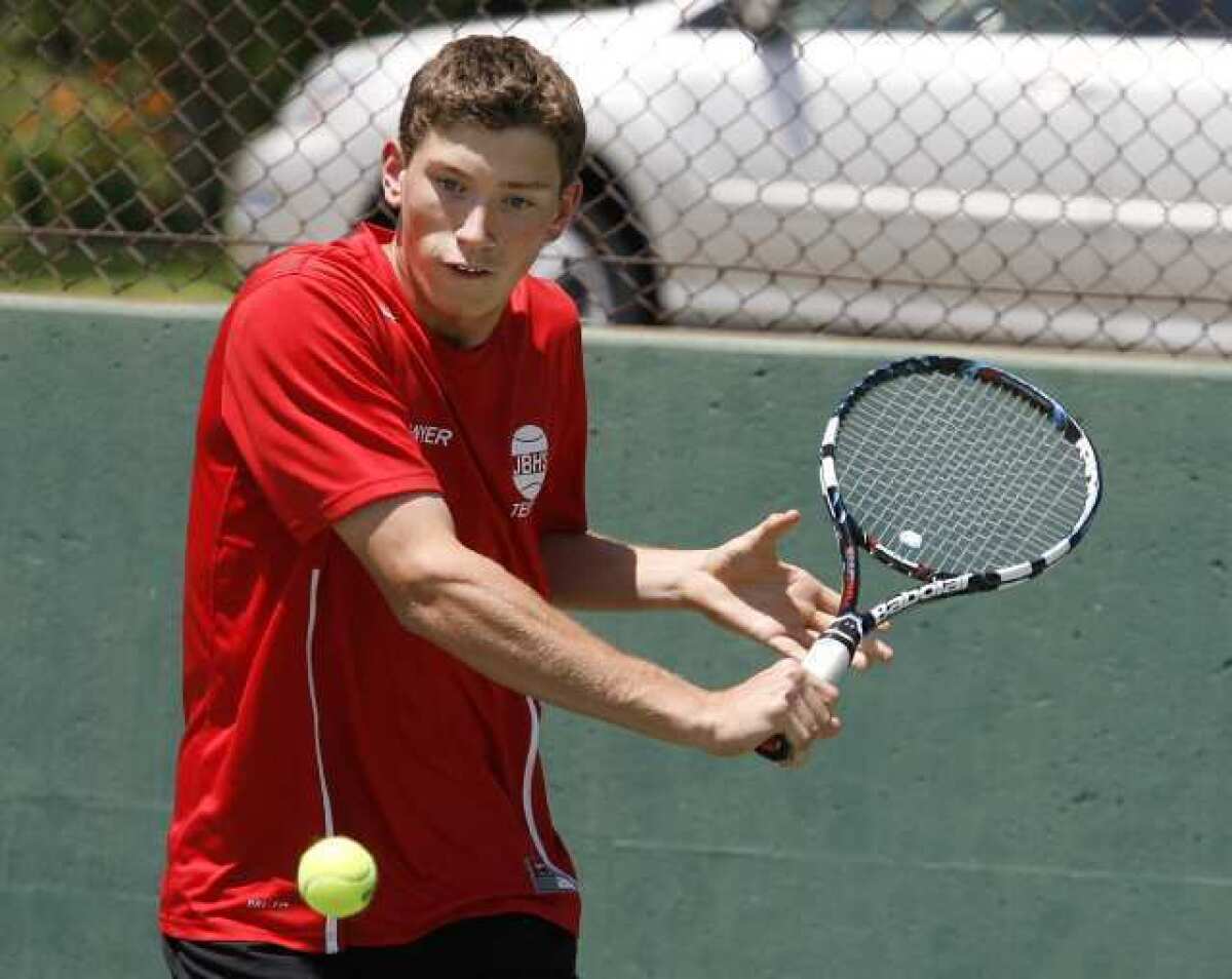 Burroughs' Sawyer Patterson makes a forehand return in a semifinal match for the Pacific League boys tennis finals at Pasadena High School on Wednesday, May 1, 2013. (Tim Berger/Staff Photographer)