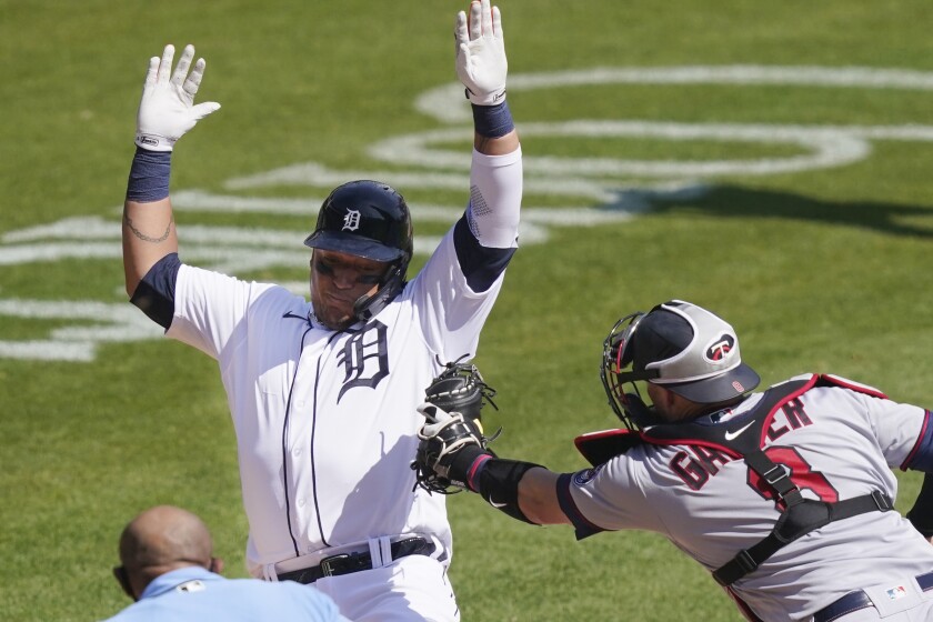Detroit Tigers' Miguel Cabrera is tagged out by Minnesota Twins catcher Mitch Garver (8) as he tries to score from third during the sixth inning of a baseball game, Wednesday, April 7, 2021, in Detroit. (AP Photo/Carlos Osorio)