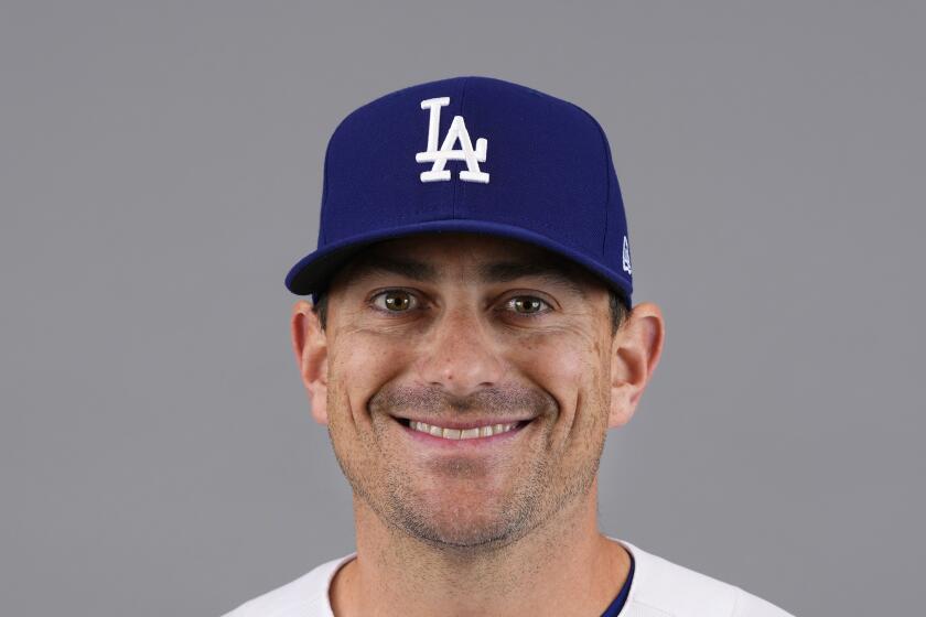 Relief pitcher Daniel Hudson poses for a portrait in his white Dodgers uniform